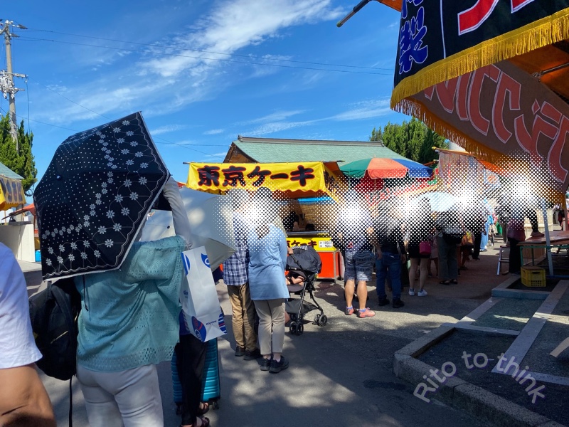 津嶋神社の通行券を購入する参拝者の列と参道に並ぶ屋台